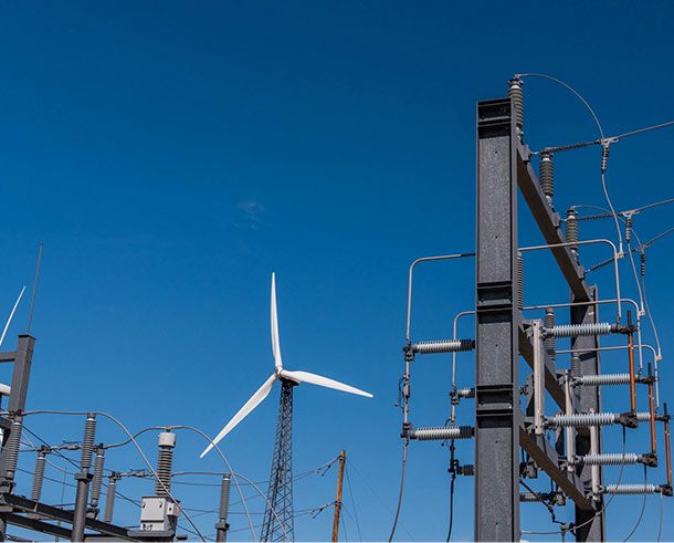 A wind turbine is shown next to power lines.